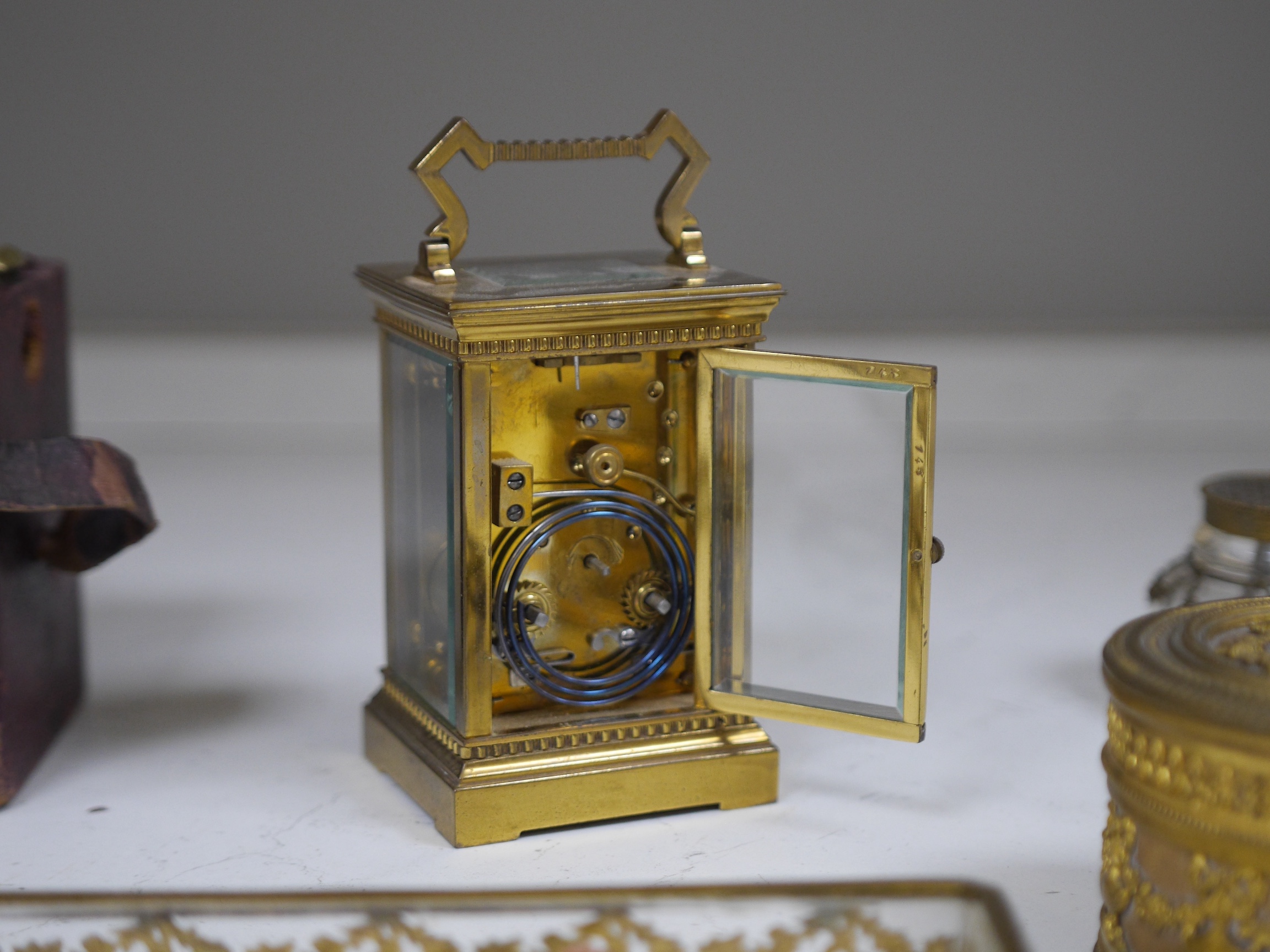 A brass cased carriage clock and five ormolu mounted glass desk accessories, clock 12cm high. Condition - unknown if clock working, desk accessories fair to good condition.